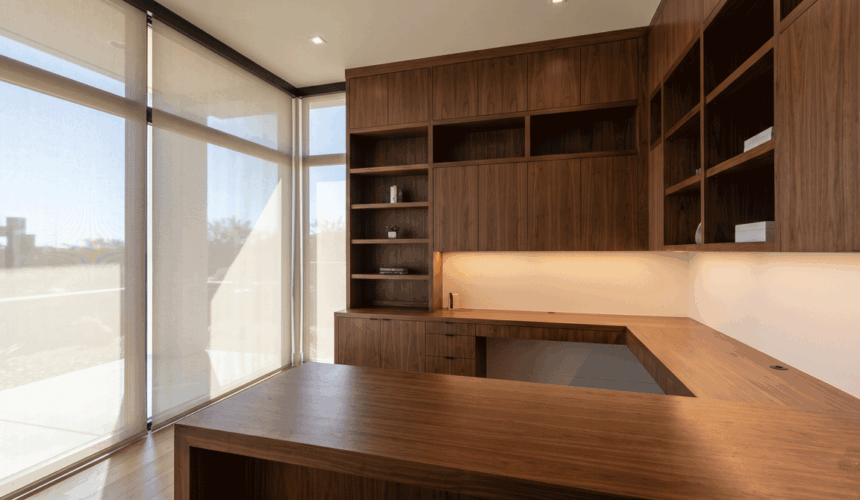 the whole space establishes the integration of custom dark wood cabinetry, task lighting, and filtered desert daylight.
